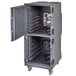 A Cambro tall profile metal food holding cabinet with open doors on wheels.