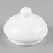 A white round object with a white lid and a small ball on top.