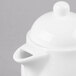 a white teapot with a lid