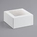 A white square bakery box with a clear window on top.
