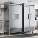 A True T-35-HC reach-in refrigerator with solid doors in a kitchen.