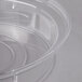 A clear plastic low profile plate cover with a handle.