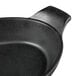 A black faux cast iron oval skillet with handles.