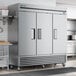 A True stainless steel reach-in freezer with a solid door.