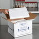 A hand opening a white Polar Tech Thermo Chill insulated shipping box.