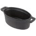 An American Metalcraft pre-seasoned black cast iron oval mini Dutch oven.