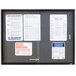 A Quartet graphite aluminum enclosed fabric cork bulletin board with several papers on it.