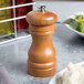 A Fletchers' Mill cherry wood salt mill on a table.