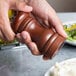 a person pouring a salt into a bowl