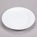 A white oval melamine platter with a rim.