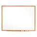 A Quartet melamine whiteboard with an oak frame.