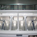 An Excellence 52" Nine Pan Gelato Dipping Cabinet freezer with a glass top filled with metal containers of gelato.