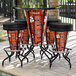 A Holland Bar Stool Clemson University pub table with a Clemson logo and matching stools on a brick patio.