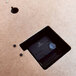 a black rectangular object in a hole