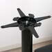A black metal Lancaster Table & Seating cast iron table base spider.