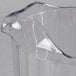 A clear plastic Rubbermaid Bouncer Pitcher with a curved edge.
