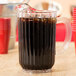 A Rubbermaid plastic pitcher filled with a drink.