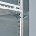 A black metal Beverage-Air shelf with white metal brackets.