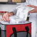 A person putting a Nordic ice mat into a cooler.