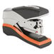 A close-up of a black and orange Swingline Optima 40 stapler.