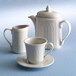 A Homer Laughlin ivory china creamer with a white background.