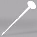 A white oval stirrer/pick with a pointed end.