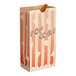 A Bagcraft EcoCraft paper popcorn bag with a striped pattern and popcorn on it.