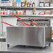 A Cecilware stainless steel electric countertop fryer with red handles.