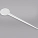 A WNA Comet white plastic disc pick with a long handle.