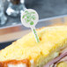 A sandwich with a white plastic disc pick in it.
