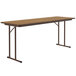 a brown rectangular table with metal legs