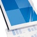 A blue and white sheet of paper with holes on the side.