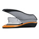 A close-up of a black and orange Swingline stapler.