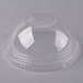 A clear plastic dome lid on a clear plastic cup.
