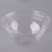 A clear plastic bowl with a round rim and a clear plastic dome lid with a round hole.