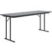 A rectangular Correll seminar table with gray granite top and black legs.