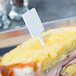 A sandwich with a WNA Comet white rectangular pick in it.