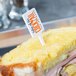 A sandwich with a WNA Comet white rectangular pick in it.