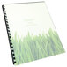 A Swingline GBC frost binding system cover with a spiral bound notebook with grass on it.