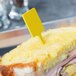 A sandwich with a WNA Comet yellow rectangular pick sticking out of it.
