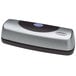 A silver and black rectangular Swingline 3 hole punch with a blue button.