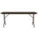 A Correll rectangular table with a walnut top and brown legs.