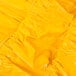 a yellow shiny fabric with a seam