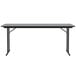 A Correll rectangular gray granite seminar table with off-set black legs.