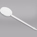 a white plastic spoon with a handle