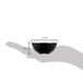 A hand holding a black Tablecraft melamine ramekin with round ribbed sides.