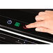 A hand pressing a button on the Fellowes Venus 2 Laminator.