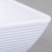 A close up of a white Tablecraft square ribbed melamine ramekin.