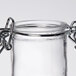 A Tablecraft glass salt and pepper shaker jar with a stainless steel clip-top lid.