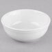 A Libbey Porcelana white oatmeal bowl on a gray surface.